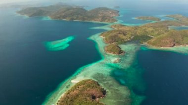 Küçük adaların ortasında mavi, masmavi suları olan havadan deniz manzaralı gölcükler. Palawan, Filipinler. Mavi lagünlü tropikal adalar, mercan resifleri. Malezya takımadalarının turkuaz adaları