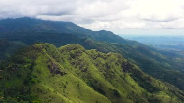 Aerial view of Mountains and green hills. Slopes of mountains with evergreen vegetation. Ella Rock, Sri Lanka.