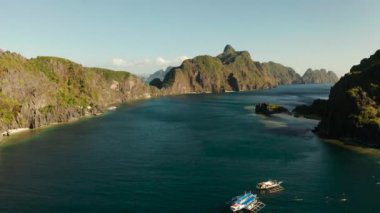 Tropikal körfezi, kayalık adaları, okyanus mavisi suyu olan hava manzaralı deniz manzarası. adalar ve dağlarla kaplı tropikal ormanlar. El nido, Filipinler, Palawan. Tropik Dağ Sırası