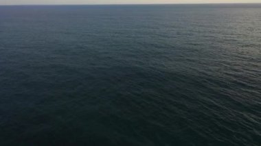 Aerial drone of Blue sea and sky with clouds at sunset.