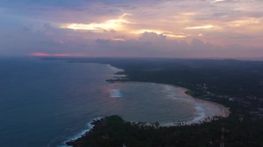 The beach and the ocean during sunset. Dickwella Beach, Sri Lanka.