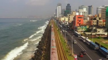 Top view of railroad with train and highway next to the ocean. Colombo, Sri Lanka.