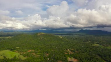Mountains covered rainforest, trees and blue sky with clouds. Sri Lanka