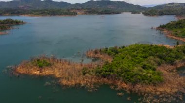 Tropical green forest in the mountains and blue lake. Kalu Ganga Reservoir, Sri Lanka.