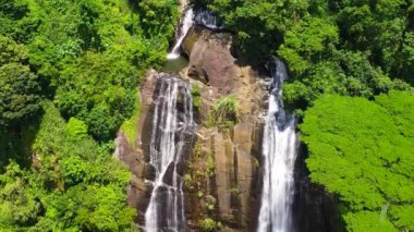 Top view of Beautiful waterfall in green forest. Tropical Hunnasgiriya Falls in mountain jungle, Sri Lanka.