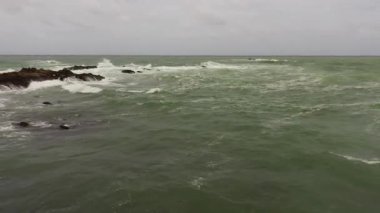 Rocks and stormy ocean with big waves. Summer and travel vacation concept