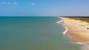 Seascape with tropical sandy beach and blue ocean. Sri Lanka. Thaalayadi Beach. Summer and travel vacation concept.