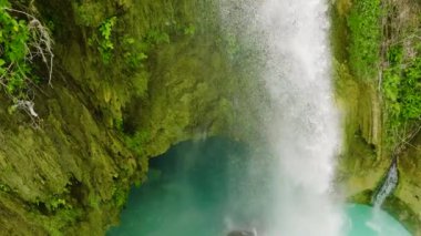 A tropical waterfall in slow motion surrounded by jungle. Cebu, Philippines.