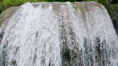 Aerial view of Lusno Falls in green forest in slow motion. Cebu, Philippines.
