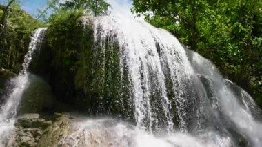 Waterfall in the rainforest. Tropical Lusno Falls in slow motion. Cebu, Philippines.