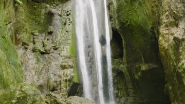 Waterfall in the tropical mountain jungle in slow motion. Binalayan Falls. Cebu, Philippines.