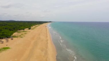 Sandy beach and turquoise water. Nilaveli Beach, Sri Lanka, Trincomalee. Summer and travel vacation concept.