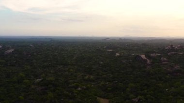 Aerial drone of Sunset over the jungle on the background of mountains in the national park of Sri Lanka.