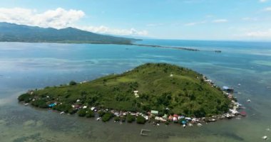 Aerial drone of tropical island with a fishing village. Diutay Island. Philippines.