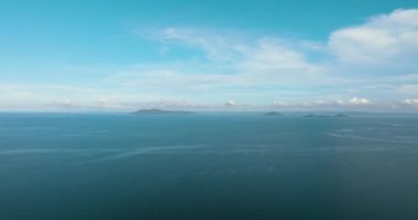 Tropical islands in the blue sea against the background of the sky and clouds. Philippines.