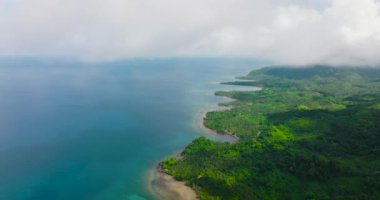 The coastline of Balabac Island and the blue sea through the clouds. Palawan. Philippines.