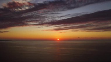 Aerial view of Beautiful sunset background from the colorful beams on the sky. Sunrise over ocean. Seascape.
