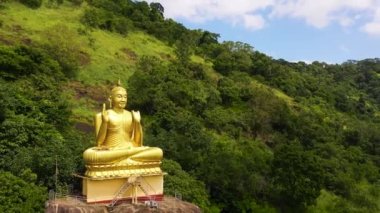 Top view of Buddha statue at a hill slope near Aluvihare Rock Temple. Aluvihara Rock Temple, Matale Sri Lanka.