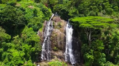 A beautiful Hunnasgiriya waterfall among the rainforest and vegetation. Hunas Falls, Sri Lanka.