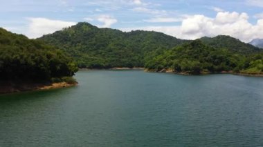 Tropical landscape: mountains and jungle hills with lake. Victoria Reservoir, Sri Lanka.
