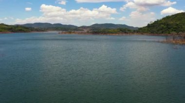 A tropical landscape with a blue lake among the mountain peaks. Kalu Ganga Reservoir.