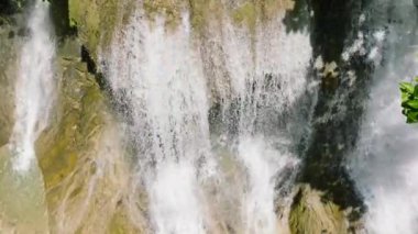 Waterfall in a tropical forest. Aerial view of Lusno Falls in slow motion. Cebu, Philippines.