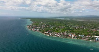 Aerial view of coast of Moalboal with hotels and dive centers. A popular place for divers. Philippines, Cebu.