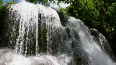 Waterfall in the green forest. Lusno Fallsin slow motion. Cebu, Philippines.