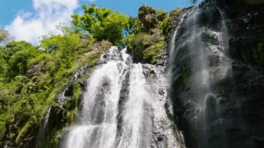 Waterfall in a tropical forest. Slow motion. Balea Falls in the jungle. Negros, Philippines.