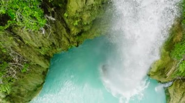 Top view of waterfall in slow motion. Inambakan Falls in the green forest. Cebu, Philippines.