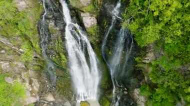 Aerial drone of Waterfall in a mountain gorge. Slow motion. Balea Falls in the jungle. Negros, Philippines.