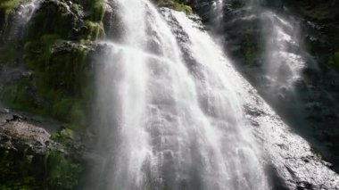 Aerial view of Waterfall among tropical jungle with green plants. Slow motion. Balea Falls in the jungle. Negros, Philippines.