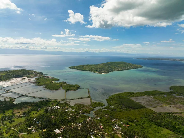 Aerial view of coastline of the island of Cebu against the backdrop of the blue sea and the island of Negros. Philippines.
