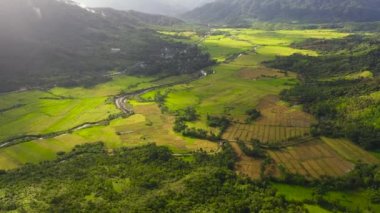 Top view of Mountain slopes with rainforest and a mountain valley with farmland. Philippines.