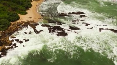 Rocky sandy beach and ocean surf. Secret Beach Mirissa,Sri Lanka. Travel concept.