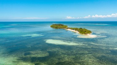 Island with a sandy beach and azure water. Tanduyong Island, Philippines.