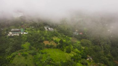 Top view of houses in the town of Ella on the slopes of the mountains with clouds. Sri Lanka.