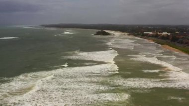 Wide sandy beach and ocean surf. Matara beach, Sri Lanka.