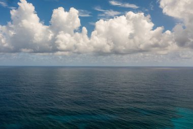 Tropical blue sea and blue sky with clouds. Seascape, aerial view. Flight over the sea.