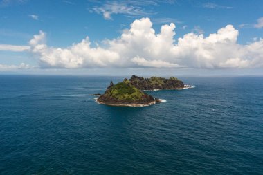 Aerial view of rocky tropical island in the blue ocean. Dos Hermanos Island. Santa Ana, Cagayan. Philippines.