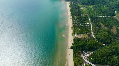 Tropical beach with palm trees. Sugar Beach. Sipalay, Negros, Philippines.