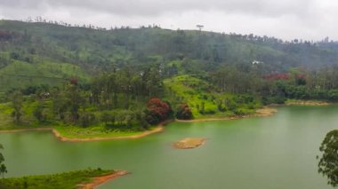 Aerial drone of Hills with tea plantations around the lake in the mountains. Maskeliya, Castlereigh, Sri Lanka.