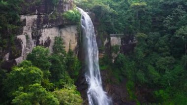 Waterfall among tea plantations. Ramboda Falls, Sri Lanka.