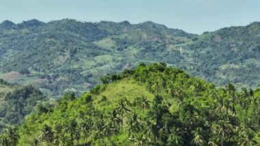 Mountain slopes with rainforest and a mountain valley with farmland. Negros, Philippines
