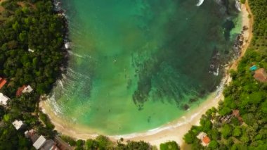Aerial view of Tropical sandy beach and blue sea. Hiriketiya, Sri Lanka.