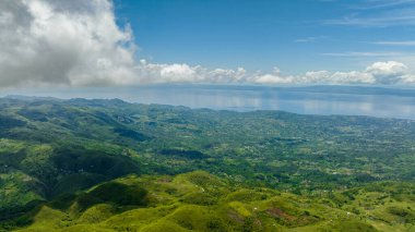 Mountains to the sea and the island of Cebu view from above. Negros, Philippines