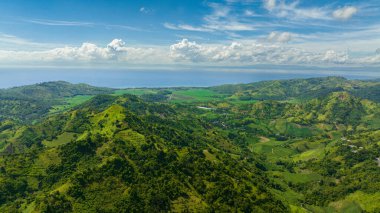 Top view of mountain landscape with green hills and farmland. Negros, Philippines