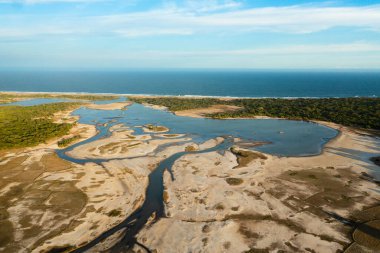 Rivers and lakes in the national park against the background of blue sky and ocean during sunset. Sri Lanka.