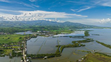Aerial drone of coast of Negros Island with farmland and town. Negros, Philippines.