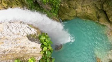 Waterfall in slow motion surrounded by green vegetation. Inambakan Falls in slow motion. Cebu, Philippines.
